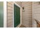 A green front door with the unit number and shingle siding is brightly illuminated at 306 S Cedar St # 10, Charlotte, NC 28202
