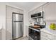 Contemporary kitchen featuring stainless steel appliances and bright countertops, for a modern look at 306 S Cedar St # 10, Charlotte, NC 28202