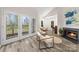 Bright living room boasts a fireplace, neutral walls, and balcony access with city views at 306 S Cedar St # 10, Charlotte, NC 28202