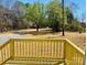 Enjoy outdoor living with this home's backyard, featuring a charming wooden deck and lush greenery at 3144 Rickwood Dr, Newton, NC 28658