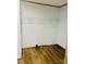 Bedroom closet with white wire shelving and wood laminate flooring at 3144 Rickwood Dr, Newton, NC 28658