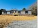 Charming single-story home with gray siding, stone accents, and a well-maintained front yard at 3144 Rickwood Dr, Newton, NC 28658