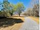 Scenic property featuring a home set back from a long driveway surrounded by mature trees at 3144 Rickwood Dr, Newton, NC 28658