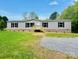 Charming one-story home with gray siding, black shutters, and a well-maintained front yard at 3144 Rickwood Dr, Newton, NC 28658