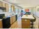 Bright and modern kitchen featuring an island with seating and sleek, black appliances at 3144 Rickwood Dr, Newton, NC 28658
