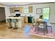 Well-lit kitchen features wooden cabinetry, a kitchen island, and a cozy dining area at 3144 Rickwood Dr, Newton, NC 28658