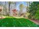 View of the backyard showing manicured lawn and mature trees at 3717 Bodenham Ct, Charlotte, NC 28215