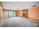 Large basement with brick fireplace, double doors to the outside, and neutral carpet at 3717 Bodenham Ct, Charlotte, NC 28215