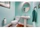 A powder room with pedestal sink, toilet, and decorative mirror at 3717 Bodenham Ct, Charlotte, NC 28215