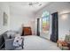 Bright bedroom featuring a large window, vaulted ceiling, and stylish furniture arrangement at 3717 Bodenham Ct, Charlotte, NC 28215