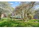 Beautiful home with manicured lawn, mature trees, and blooming flowers in a well-maintained landscape at 3717 Bodenham Ct, Charlotte, NC 28215