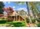 The exterior of the house shows a wooden deck, stairs leading to the yard and lush greenery at 3717 Bodenham Ct, Charlotte, NC 28215