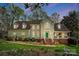 Charming home featuring a manicured lawn, lush landscaping, and a welcoming front porch with green door at 3717 Bodenham Ct, Charlotte, NC 28215