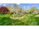 The front yard has a patterned lawn, stone bed and mature flowering trees at 3717 Bodenham Ct, Charlotte, NC 28215
