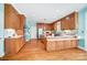 Spacious kitchen with light blue walls, stainless steel appliances, wooden cabinets and hardwood flooring at 3717 Bodenham Ct, Charlotte, NC 28215
