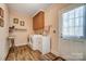 A well-lit laundry room with modern washer and dryer and a utility sink for added convenience at 3717 Bodenham Ct, Charlotte, NC 28215