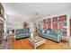Inviting living room featuring hardwood floors, a brick fireplace, and built-in bookshelves at 3717 Bodenham Ct, Charlotte, NC 28215