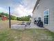 Backyard patio with a fire pit, seating, grill, and outdoor entertainment space at 3810 New Salem Rd, Monroe, NC 28110