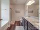 Another view of the bathroom shows double vanities with granite countertops, a shower, and a soaking tub at 3810 New Salem Rd, Monroe, NC 28110