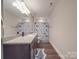Bathroom with granite countertop vanity, shark-themed shower curtain, and wood-look floors at 3810 New Salem Rd, Monroe, NC 28110