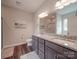 Elegant bathroom featuring double vanities with granite countertops and modern fixtures and a door to the commode at 3810 New Salem Rd, Monroe, NC 28110