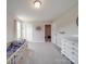 Neutral-toned Bedroom featuring a wooden crib, white dresser, and carpeted floors at 3810 New Salem Rd, Monroe, NC 28110