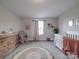 Serene Bedroom with wooden changing table, comfortable rocking chair, and stylish decor at 3810 New Salem Rd, Monroe, NC 28110