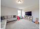 Another view of the bonus room with carpeted floors and abundant natural light at 3810 New Salem Rd, Monroe, NC 28110