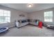 Spacious bonus room with carpeted floors, abundant natural light, and ample space for play and relaxation at 3810 New Salem Rd, Monroe, NC 28110