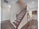 Inviting entryway featuring a staircase with decorative iron railings and views to the laundry room and other spaces at 3810 New Salem Rd, Monroe, NC 28110