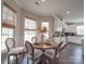Bright eat-in kitchen features a cozy breakfast nook with a wood table set for four with windows at 3810 New Salem Rd, Monroe, NC 28110