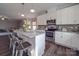 Bright kitchen with stainless steel appliances and a large island with seating overlooks the living room at 3810 New Salem Rd, Monroe, NC 28110
