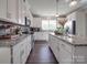 Modern kitchen with granite countertops, white cabinets, and stainless steel appliances at 3810 New Salem Rd, Monroe, NC 28110