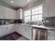 Well-lit kitchen featuring white cabinets, stainless steel appliances, and granite countertops at 3810 New Salem Rd, Monroe, NC 28110