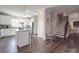 Open-concept kitchen featuring a kitchen island, white cabinets, and stainless steel appliances at 3810 New Salem Rd, Monroe, NC 28110