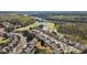 Beautiful aerial view of homes near golf course and a river surrounded by lush green trees and blue sky at 39617 Rosebay Ct, Fort Mill, SC 29707