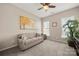 Relaxing bedroom featuring a comfortable sofa, carpet flooring, bright natural light and serene decor at 39617 Rosebay Ct, Fort Mill, SC 29707