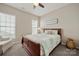 Cozy bedroom featuring a comfortable bed with soft bedding, carpet flooring, and window with blinds at 39617 Rosebay Ct, Fort Mill, SC 29707