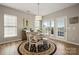 Well-lit dining area with a round table, classic rug, and a view of the deck and outdoors at 39617 Rosebay Ct, Fort Mill, SC 29707