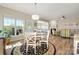 Bright dining area with a cozy round table, leading to a living room with a fireplace and outdoor access at 39617 Rosebay Ct, Fort Mill, SC 29707