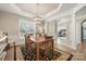 Elegant dining room with coffered ceiling, wood floors, and a view to the adjacent home office at 39617 Rosebay Ct, Fort Mill, SC 29707