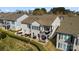 Aerial view of a two-story house showcasing an outdoor patio, balcony, and lush landscaping, perfect for outdoor living at 39617 Rosebay Ct, Fort Mill, SC 29707