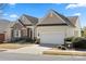 Attractive single Gathering home with an attached garage, lush front yard, and charming architectural details at 39617 Rosebay Ct, Fort Mill, SC 29707