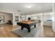 A spacious game room with a pool table, wet bar, and access to other living spaces for entertaining at 39617 Rosebay Ct, Fort Mill, SC 29707
