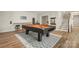 Game room features a pool table on a modern rug, and bar seating and is an ideal space to unwind at 39617 Rosebay Ct, Fort Mill, SC 29707