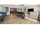 Open-concept living area with bar-height dining table and seating, flowing into relaxing seating area at 39617 Rosebay Ct, Fort Mill, SC 29707