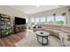 Comfortable living room with large windows and hardwood flooring offering ample natural light at 39617 Rosebay Ct, Fort Mill, SC 29707