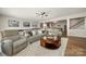 Inviting living room featuring comfortable seating and view to game area and bar at 39617 Rosebay Ct, Fort Mill, SC 29707
