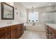 Luxurious main bathroom with soaking tub, glass shower, double vanities, and large window at 39617 Rosebay Ct, Fort Mill, SC 29707