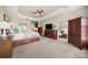 Spacious main bedroom with warm tones, carpet flooring, and dark wood furniture with lots of storage at 39617 Rosebay Ct, Fort Mill, SC 29707
